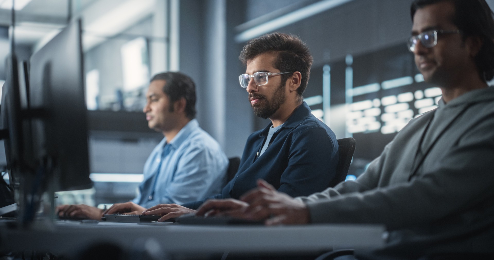 Young Passionate Specialist Working on Computer, Programming a Software for an Innovative Technological Internet Product Launch. Diverse Indian Team Working in a Startup Agency
