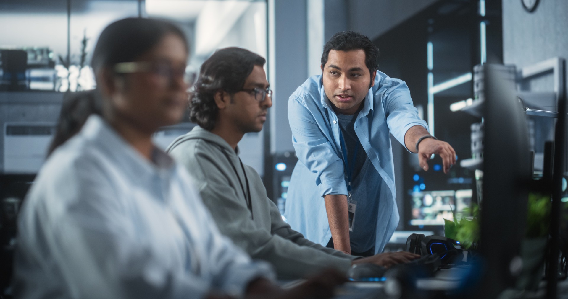 Portrait of a Team of Talented Young Indian Professionals Working in a Technological Research and Development Agency. Computer Screens with Software Code and Technical Neural Network Diagrams