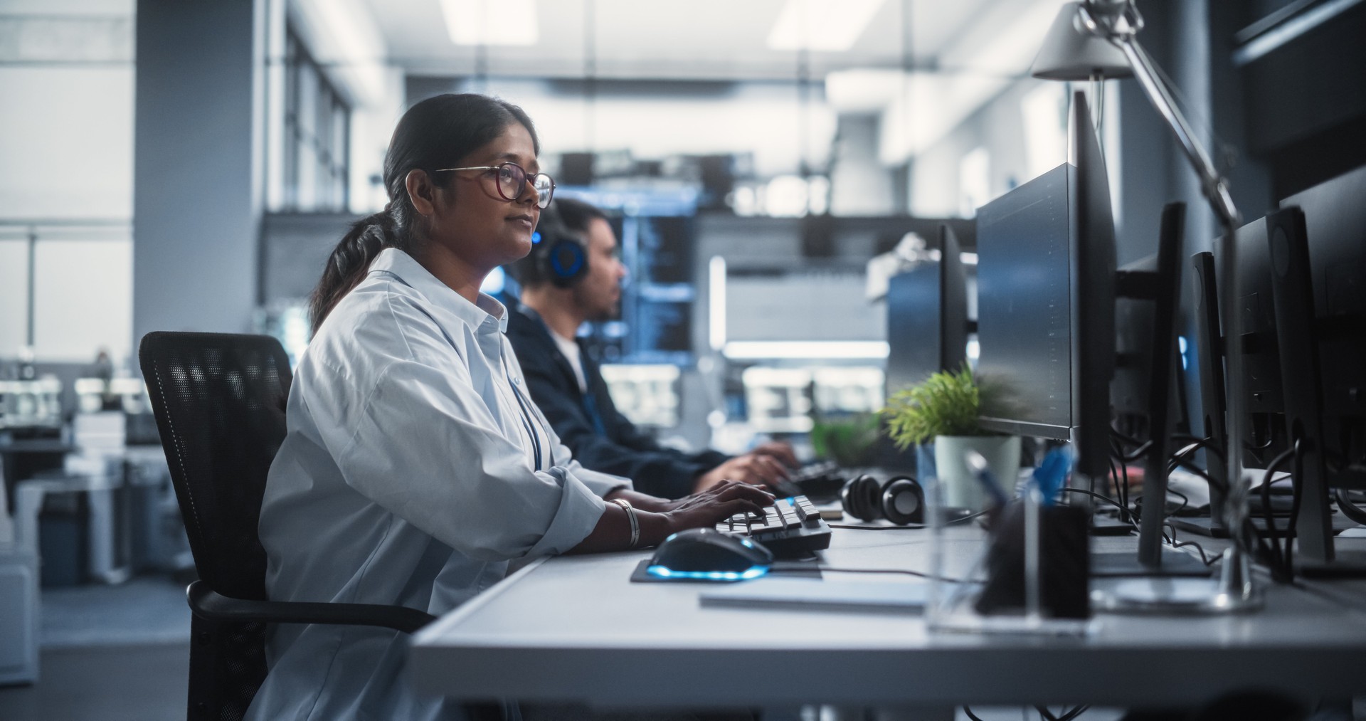 Young Female Artificial Intelligence Engineer Working on Computer in a Technological Office. Young Indian Specialist Writing Software Code for an Innovative Big Data Blockchain Project